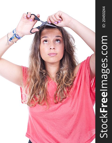 Beautiful woman cutting her hair tips with scissors