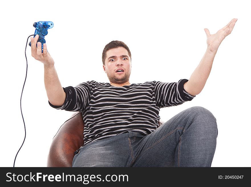 Young and furious man with a joystick for game console