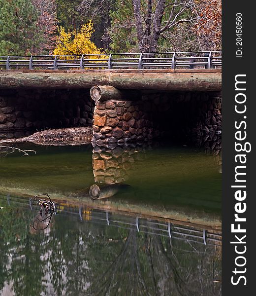 Liitle bridge reflected over the merced river in the fall,yosemite valley. Liitle bridge reflected over the merced river in the fall,yosemite valley.