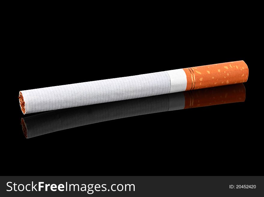 Cigarette, with reflection on a dark background. Cigarette, with reflection on a dark background.