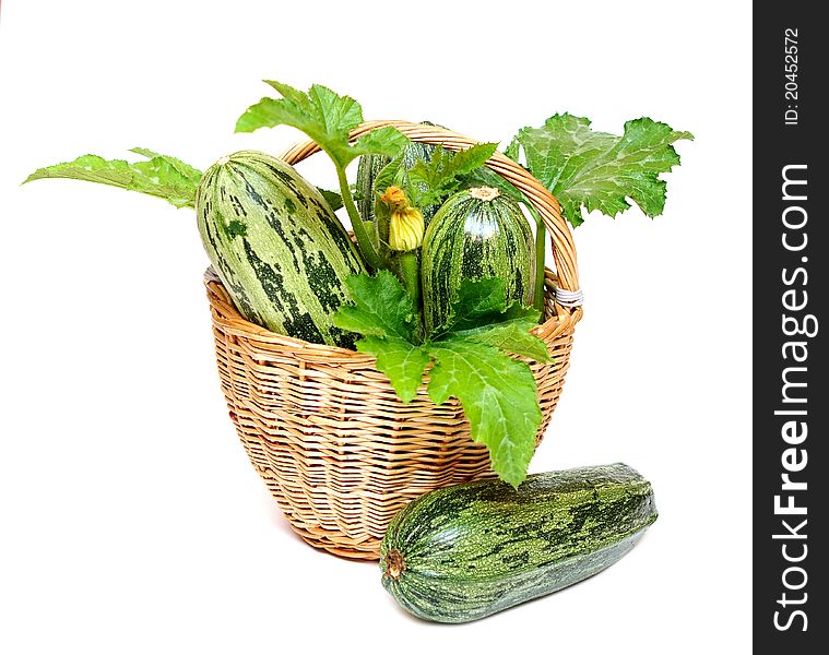 Zucchini in a basket isolated on white background