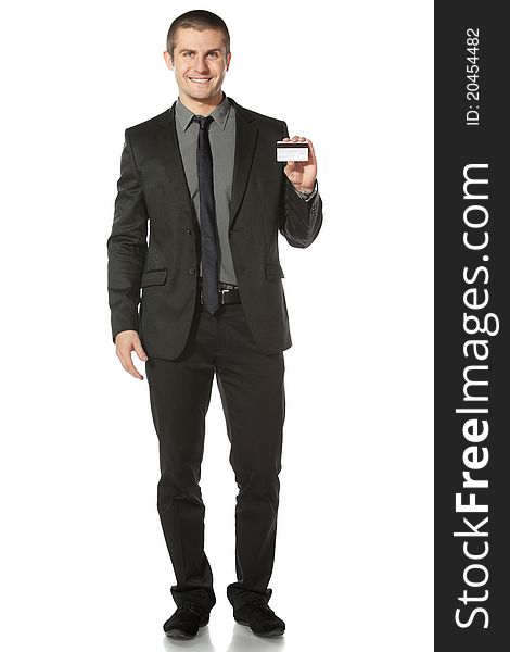 Young smiling businessman holding credit card, on white background. Young smiling businessman holding credit card, on white background