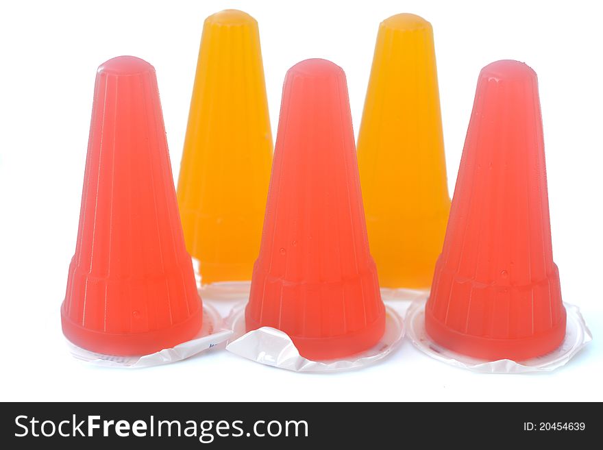 Close up of colorful jelly on white background.