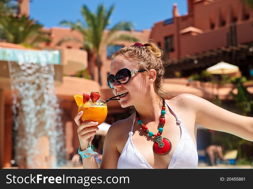 Beautiful woman in bikini holding cocktail