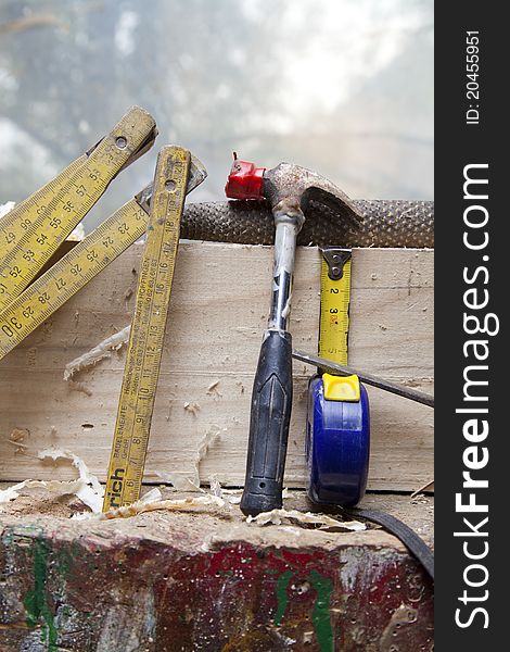 Old carpenter tools on wooden background