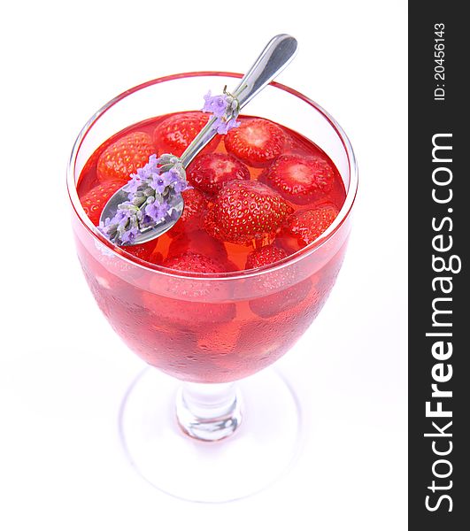 Jelly with strawberries decorated with a lavender twig in a glass cup. Jelly with strawberries decorated with a lavender twig in a glass cup