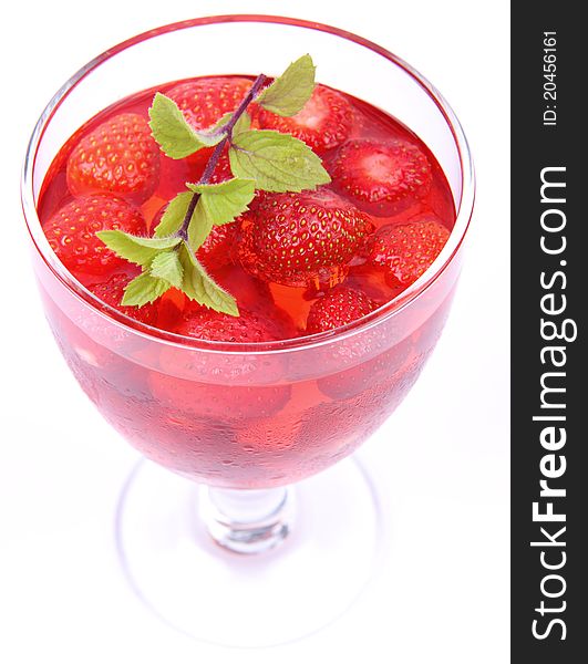 Jelly with strawberries decorated with a mint twig. Jelly with strawberries decorated with a mint twig