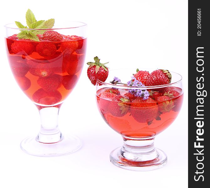 Jelly with strawberries in glass cups on white background. Jelly with strawberries in glass cups on white background