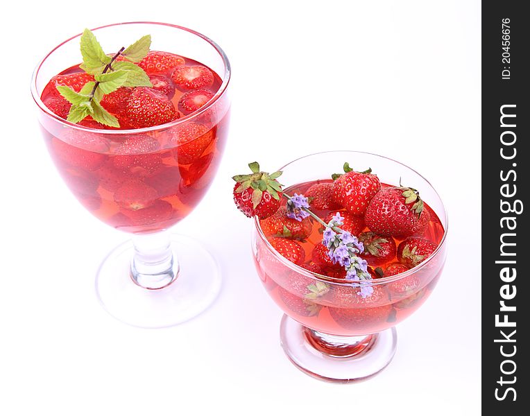 Jelly with strawberries in glass cups on white background. Jelly with strawberries in glass cups on white background