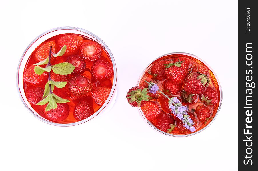 Jelly with strawberries in glass cups on white background. Jelly with strawberries in glass cups on white background