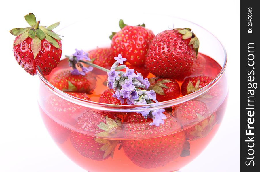 Jelly with strawberries decorated with a lavender twig in a glass cup. Jelly with strawberries decorated with a lavender twig in a glass cup