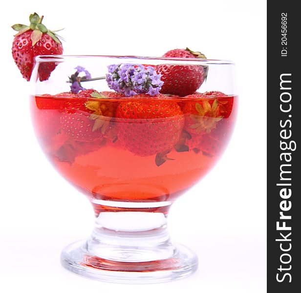 Jelly with strawberries decorated with a lavender twig in a glass cup. Jelly with strawberries decorated with a lavender twig in a glass cup