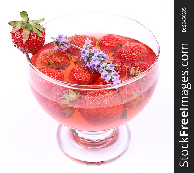 Jelly with strawberries decorated with a lavender twig in a glass cup. Jelly with strawberries decorated with a lavender twig in a glass cup