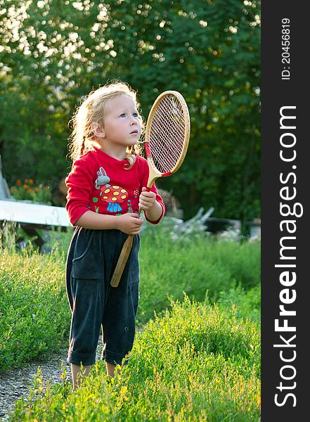 The little girl plays with a racket in badminton. Shallow DOF