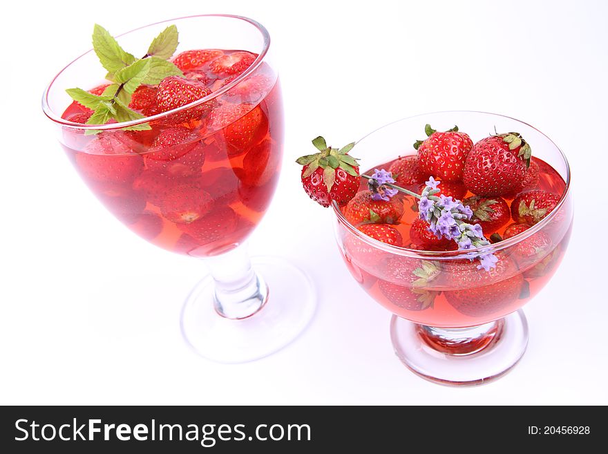 Jelly with strawberries in glass cups on white background. Jelly with strawberries in glass cups on white background