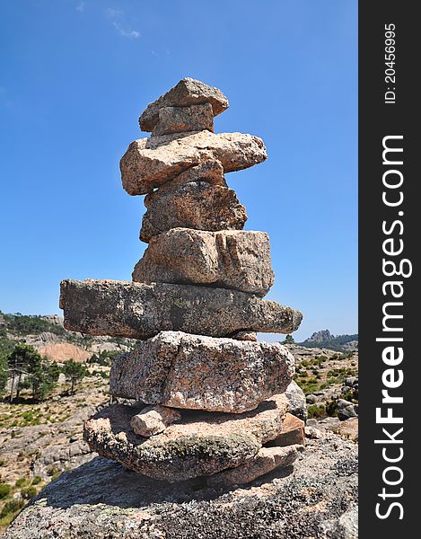 Cairn on rocky  mountains on  blue sky background. Cairn on rocky  mountains on  blue sky background