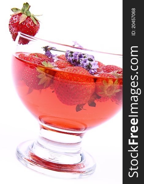 Jelly with strawberries decorated with a lavender twig in a glass cup. Jelly with strawberries decorated with a lavender twig in a glass cup