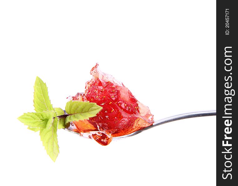 Piece of Strawberry Tart on a fork decorated with mint twig. Piece of Strawberry Tart on a fork decorated with mint twig