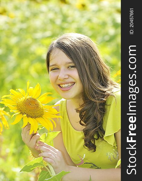 Beauty teen girl and sunflowers in summer time