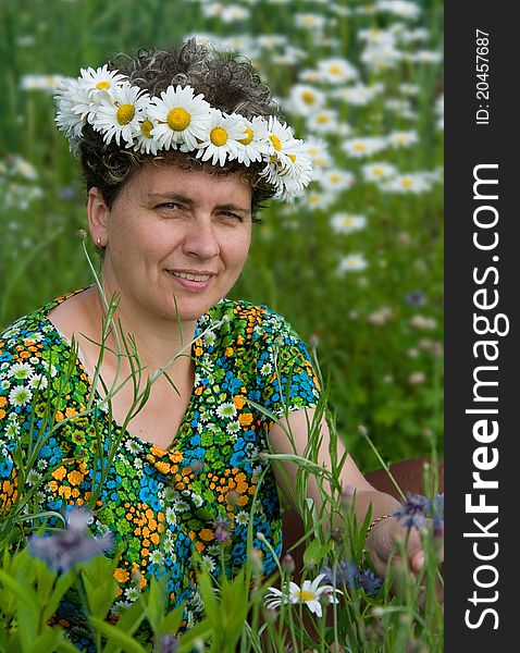 Woman wearing a wreath of wild flowers daisies. Woman wearing a wreath of wild flowers daisies