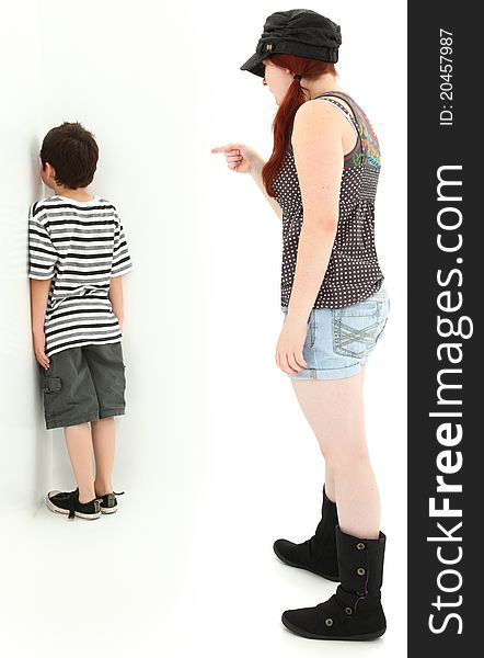 Babysitter punishing child with nose on wall in corner. Babysitter punishing child with nose on wall in corner.