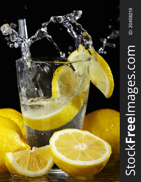 Cocktail with fresh wet lemons on black background. Cocktail with fresh wet lemons on black background