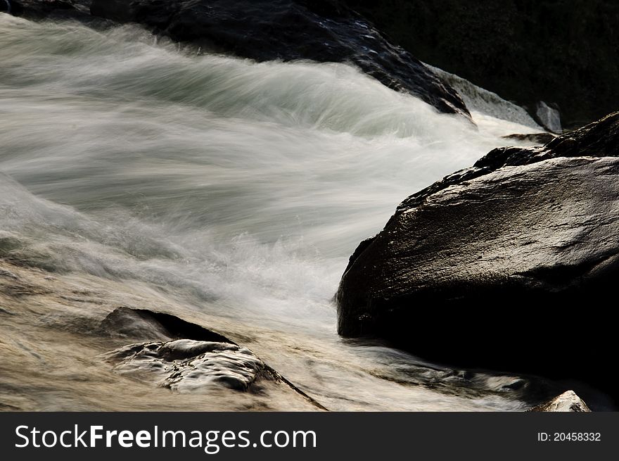 The photo depicts the fast flowing waters of Teesta, a small Himalayan river amidst rocky boundaries. The photo depicts the fast flowing waters of Teesta, a small Himalayan river amidst rocky boundaries.