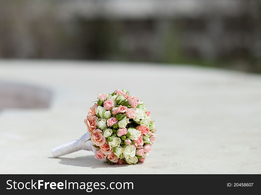 Wedding bouquet on the white stone background