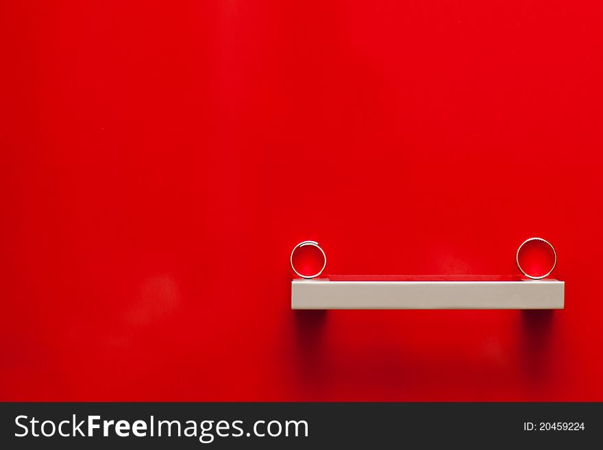 Wedding rings on the red background