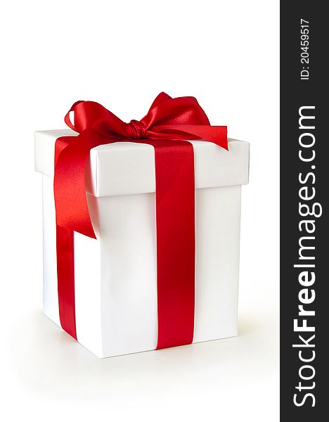 Gift box with red ribbon isolated on white