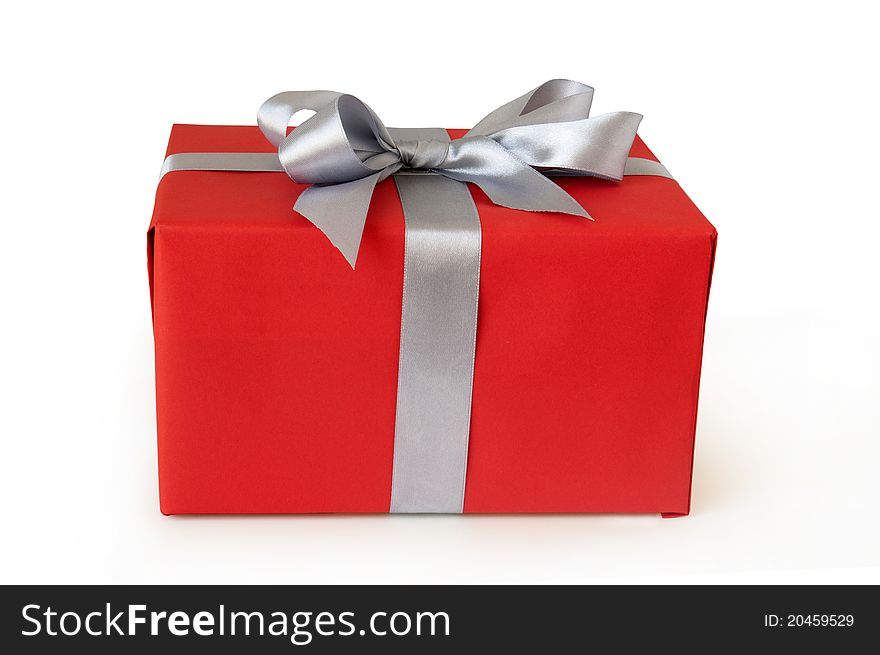 Red gift box with silver ribbon isolated on white