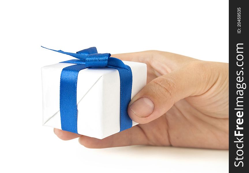 Gift box with blue ribbon in hand on white. Gift box with blue ribbon in hand on white