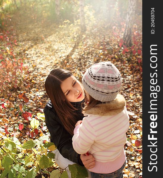 Two sisters in autumn forest