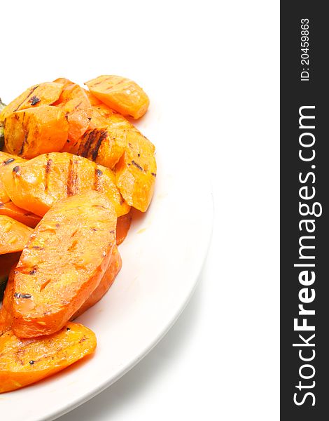 Grilled vegetables: carrot. Sliced​​. Lie on a white plate. Isolated on a white background. Grilled vegetables: carrot. Sliced​​. Lie on a white plate. Isolated on a white background.