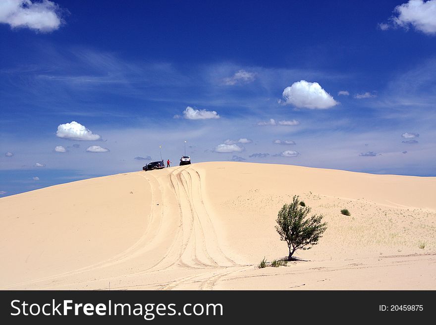 Jeep in the desert under blue sky. Jeep in the desert under blue sky
