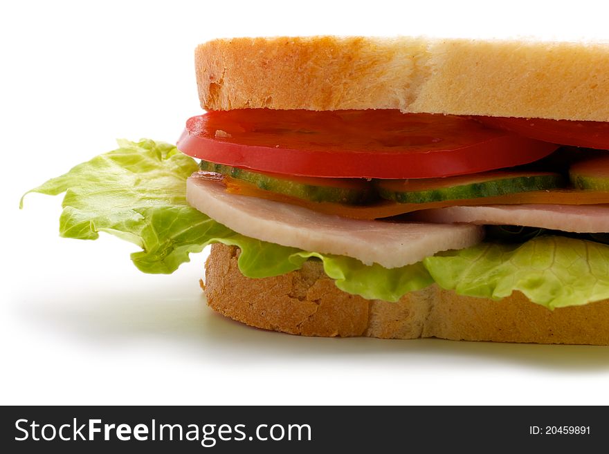 Part of the sandwich. Isolated on white background. Sandwich consists of bread, cucumbers, tomatoes, cheese, ham and greens. Isolated on a white background. Part of the sandwich. Isolated on white background. Sandwich consists of bread, cucumbers, tomatoes, cheese, ham and greens. Isolated on a white background.