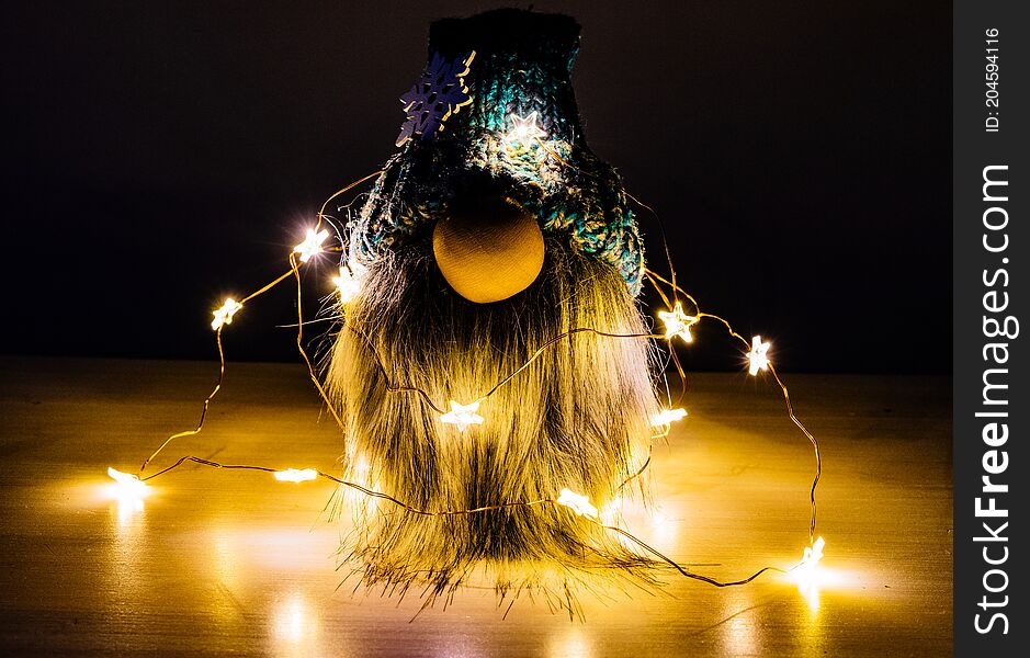 Bearded dwarf with Christmas lights.

Handmade bearded man looking forward to the Christmas holidays.