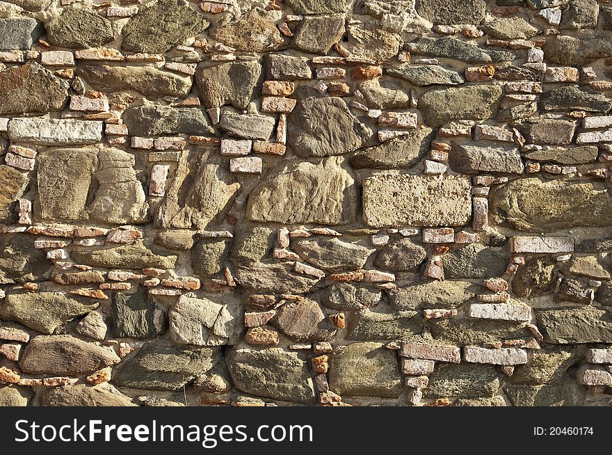 Old stone wall with some bricks in Portugal