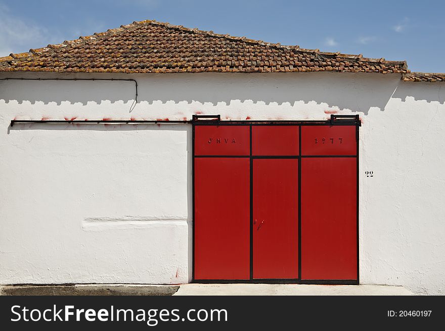 Red sliding gate in a warehouse, Portugal. Red sliding gate in a warehouse, Portugal