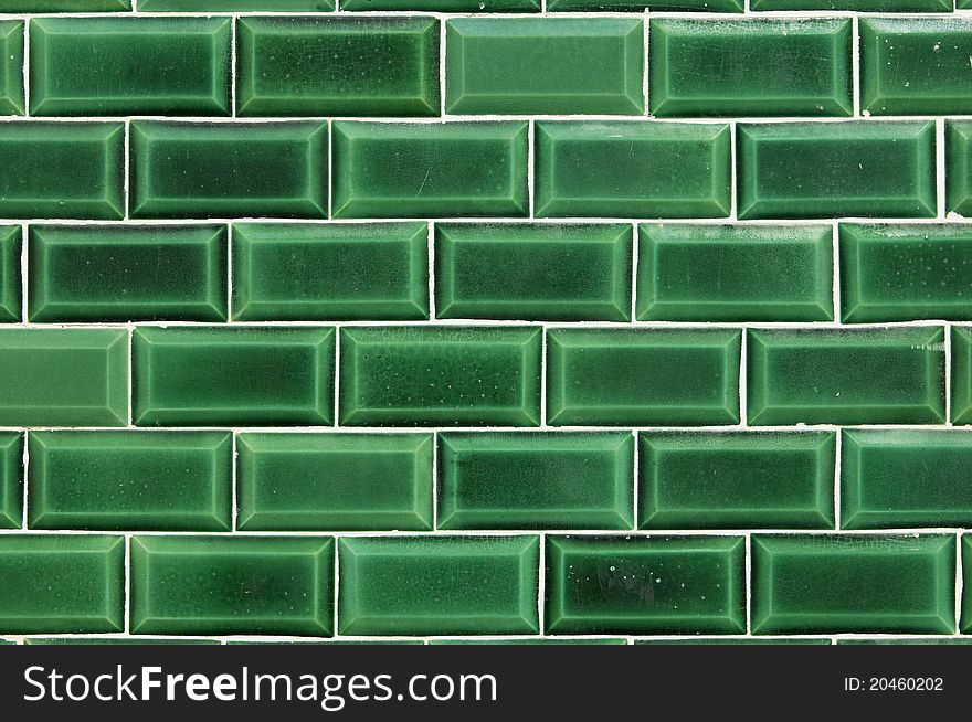 Closeup of a wall covered with green decorative tiles