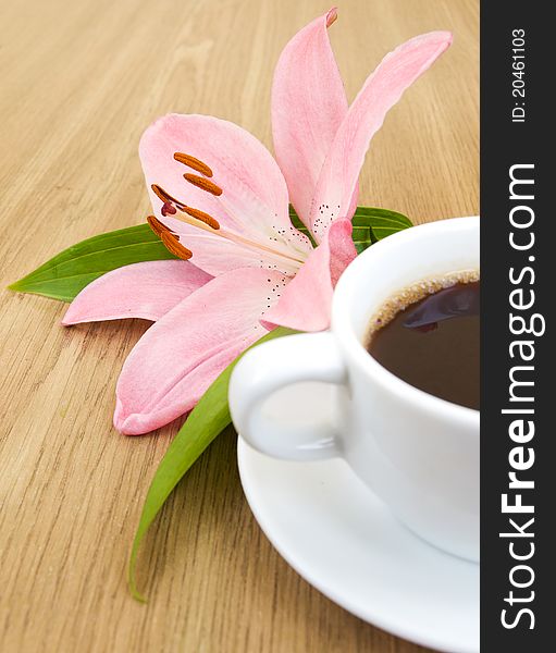 Cup of coffee and pink lily