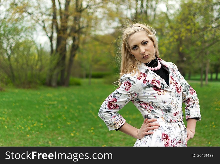 Portrait of blonde girl standing in the park. Portrait of blonde girl standing in the park