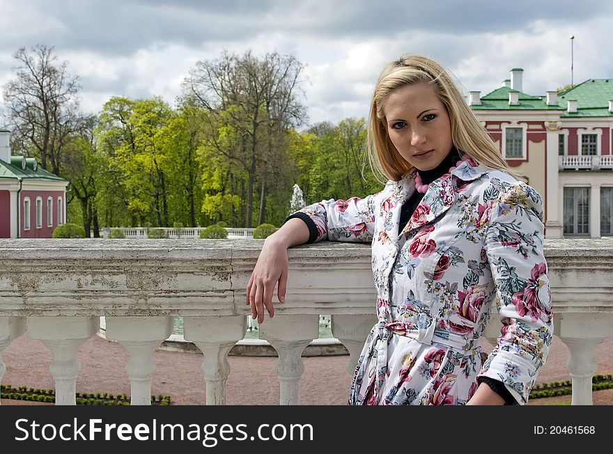 Blonde girl standing against the background of an old palace. Blonde girl standing against the background of an old palace