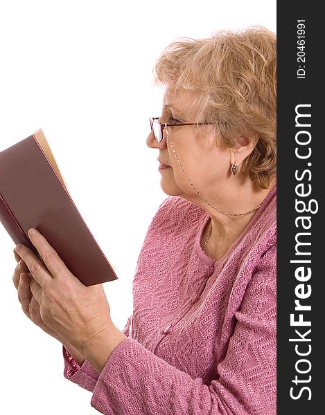 The elderly woman reads the book on white