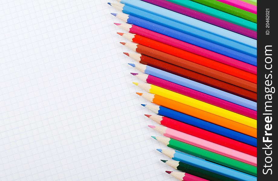 A number of pencils on school writing-book. A number of pencils on school writing-book