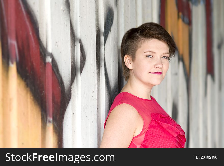 Young Woman Next To Graffiti Wall