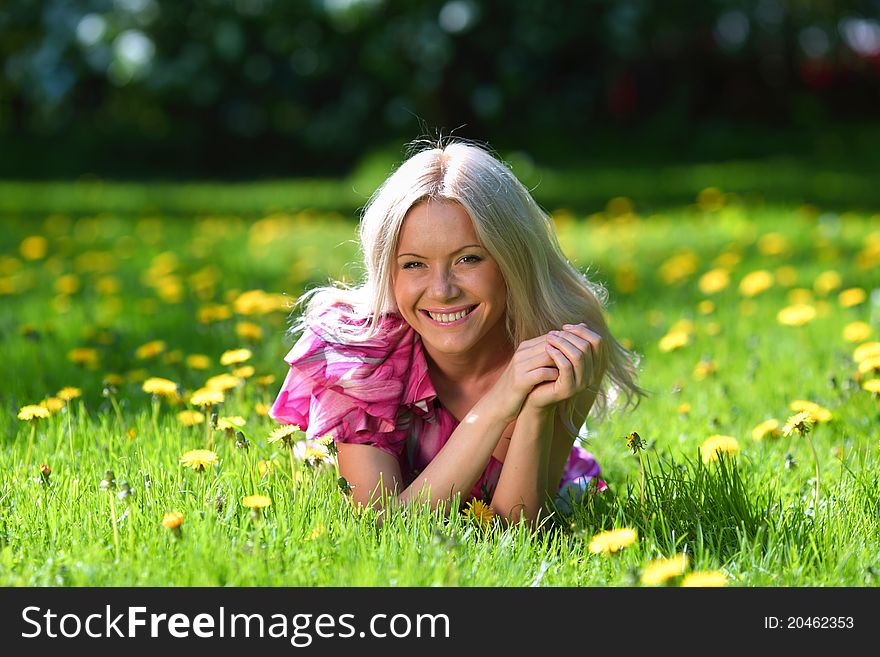 Girl lying on the field of dandelions. Girl lying on the field of dandelions