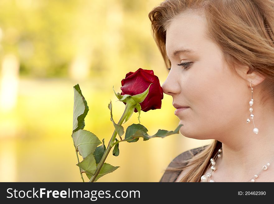 Portrait of young woman with a rose