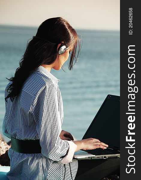Woman work on laptop sea on background. Woman work on laptop sea on background