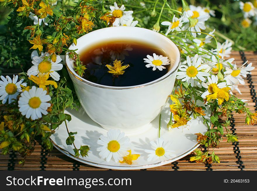 A cup of black tea with herbs. A cup of black tea with herbs